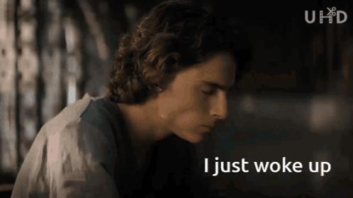 A Close Up Of A Man 'S Face With The Words I Just Woke Up Below Him GIF