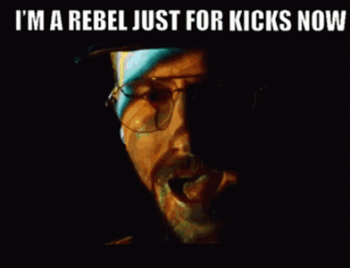 A Close Up Of A Man 'S Face With The Words `` I 'M A Rebel Just For Kicks Now '' . GIF