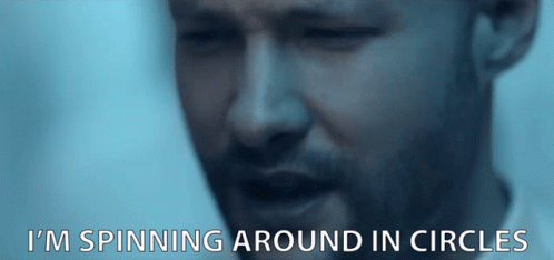 A Close Up Of A Man 'S Face With The Words I 'M Spinning Around In Circles Below It GIF