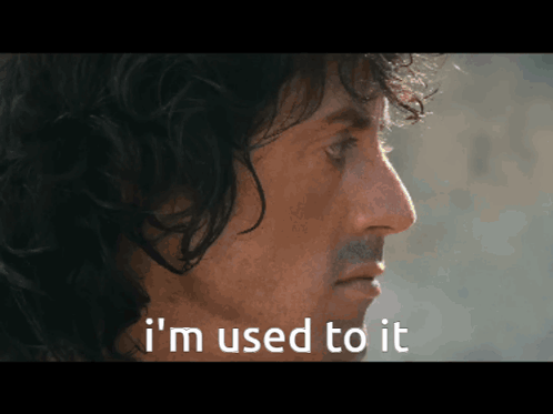 A Close Up Of A Man 'S Face With The Words " I 'M Used To It " Below Him GIF