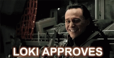 A Close Up Of A Man 'S Face With The Words `` Loki Approves '' Written Above Him . GIF