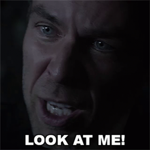 A Close Up Of A Man 'S Face With The Words Look At Me GIF