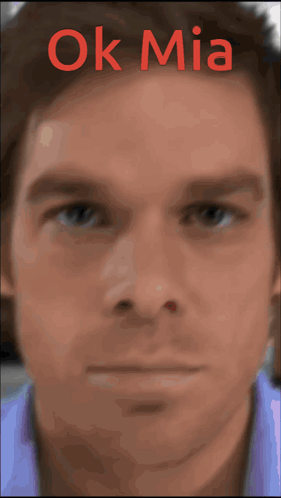 A Close Up Of A Man 'S Face With The Words Ok Mia Written Above It GIF