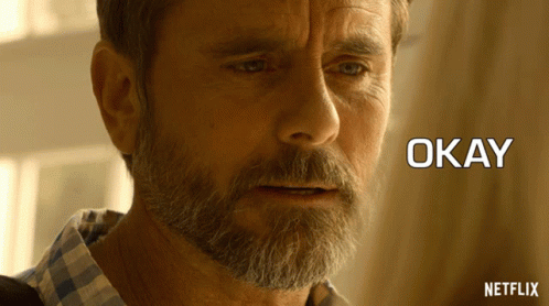 a close up of a man 's face with the words okay written below him