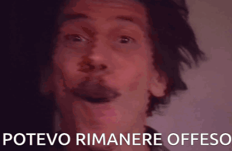 A Close Up Of A Man 'S Face With The Words Potevo Rimanere Offeso Written Below Him GIF