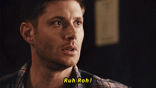 A Close Up Of A Man 'S Face With The Words Ruh Roh Above Him GIF