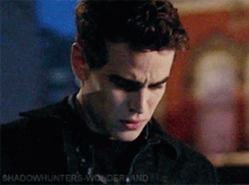 A Close Up Of A Man 'S Face With The Words Shadowhunters Wonderland In The Corner GIF