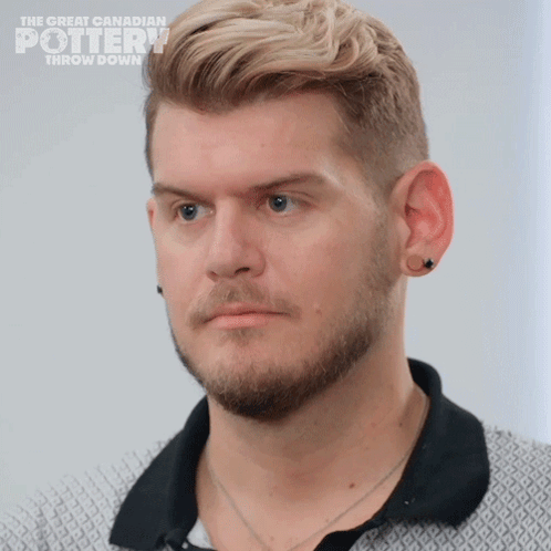 A Close Up Of A Man 'S Face With The Words The Great Canadian Pottery Throw Down On The Bottom GIF