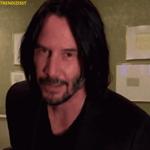 A Close Up Of A Man 'S Face With The Words Trendizisst On The Top GIF