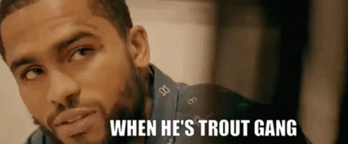 A Close Up Of A Man 'S Face With The Words `` When He 'S Trout Gang '' Written On The Bottom . GIF