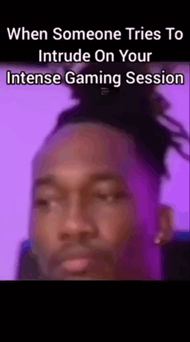 A Close Up Of A Man 'S Face With The Words When Someone Tries To Intrude On Your Intense Gaming Session On The Bottom GIF