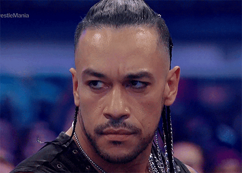 A Close Up Of A Man 'S Face With The Words Wrestlemania In The Corner GIF