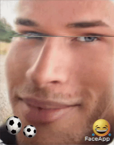 A Close Up Of A Man 'S Face With Two Soccer Balls And A Face App Logo GIF