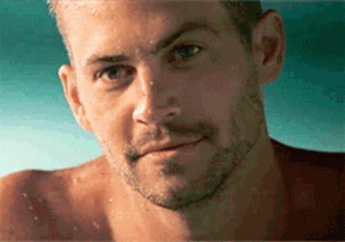 A Close Up Of A Man 'S Face With Water Drops On It GIF