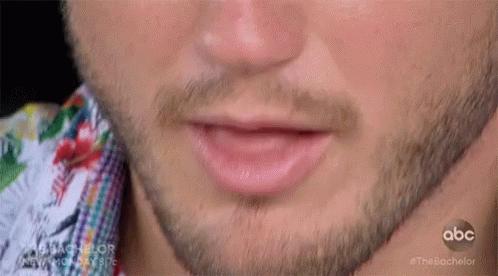 A Close Up Of A Man 'S Mouth With A Beard GIF