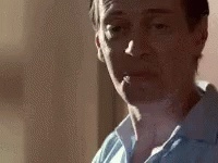 A Close Up Of A Man Smoking A Cigarette In A Room . GIF