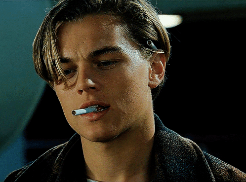 A Close Up Of A Man Smoking A Cigarette In His Mouth GIF