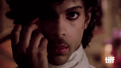 A Close Up Of A Man Talking On A Cell Phone GIF