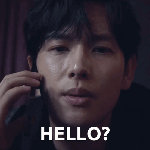 A Close Up Of A Man Talking On A Cell Phone With The Words Hello Written On The Bottom GIF