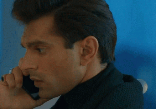 A Close Up Of A Man Talking On A Cellphone GIF