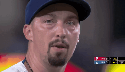 A Close Up Of A Man Wearing A Baseball Cap With The Letters Phi And Lad Visible GIF