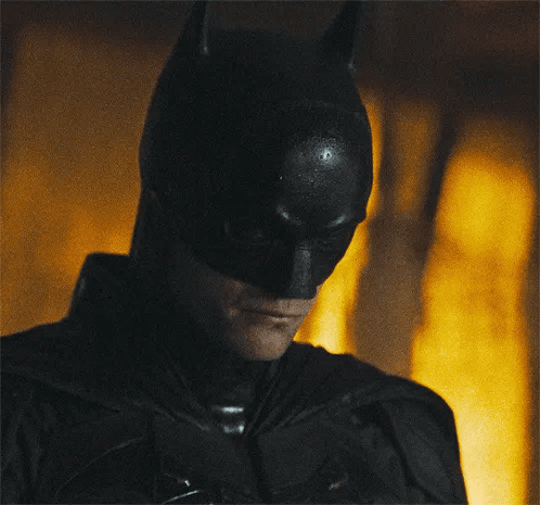 A Close Up Of A Man Wearing A Batman Costume GIF
