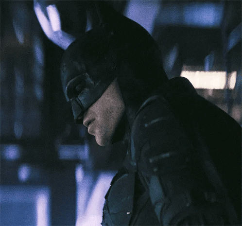 A Close Up Of A Man Wearing A Batman Costume GIF