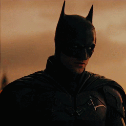 A Close Up Of A Man Wearing A Batman Mask GIF