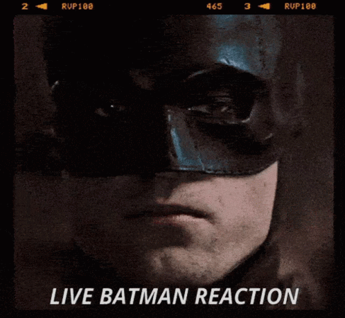 A Close Up Of A Man Wearing A Batman Mask With The Words Live Batman Reaction On The Bottom GIF