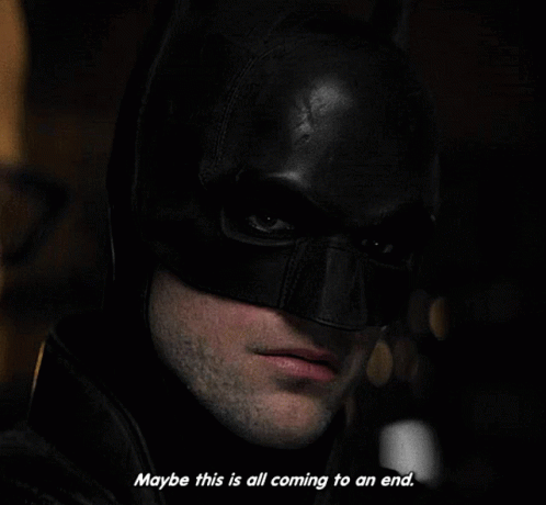 A Close Up Of A Man Wearing A Batman Mask With The Words " Maybe This Is All Coming To An End " GIF