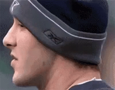 A Close Up Of A Man Wearing A Beanie And A Hat . GIF