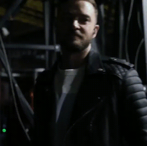 a close up of a man wearing a black leather jacket