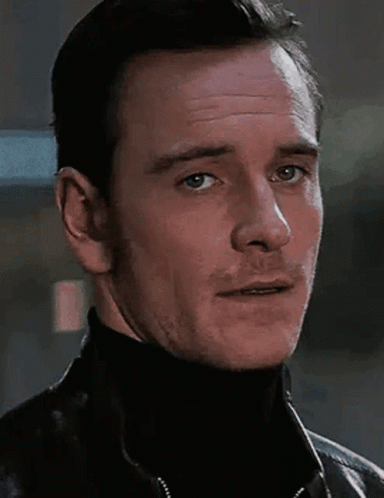 A Close Up Of A Man Wearing A Black Turtleneck And A Black Jacket GIF