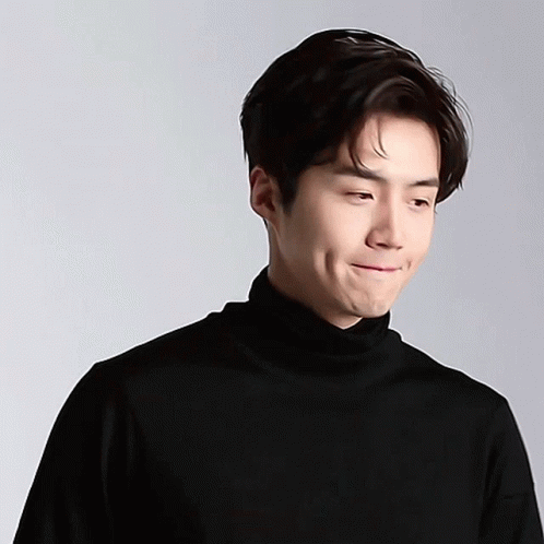 A Close Up Of A Man Wearing A Black Turtleneck GIF