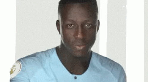 A Close Up Of A Man Wearing A Blue Shirt . GIF