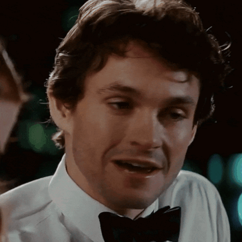 A Close Up Of A Man Wearing A Bow Tie And A White Shirt GIF