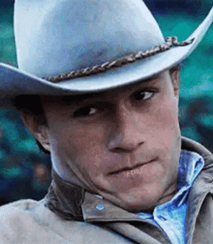 A Close Up Of A Man Wearing A Cowboy Hat GIF