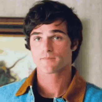 a close up of a man wearing a denim jacket