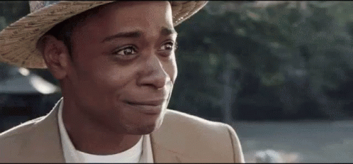 A Close Up Of A Man Wearing A Hat And A Suit Crying . GIF
