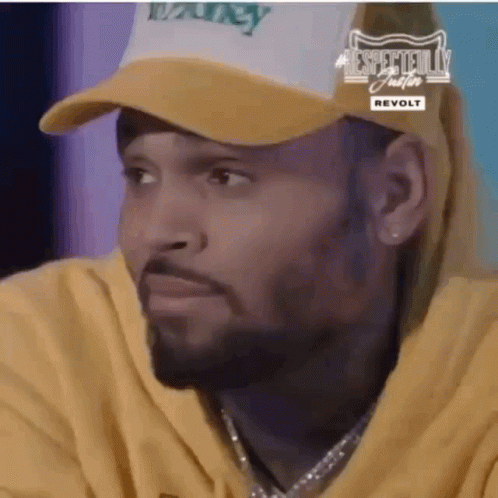 A Close Up Of A Man Wearing A Hat And A Yellow Hoodie . GIF