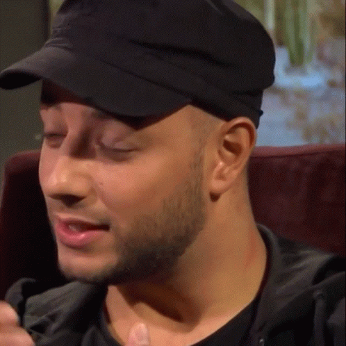 A Close Up Of A Man Wearing A Hat GIF