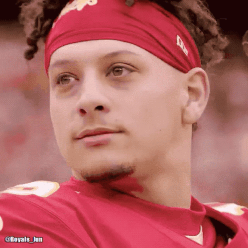A Close Up Of A Man Wearing A Headband And A Red Shirt GIF