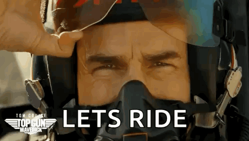 a close up of a man wearing a helmet and a gas mask with the words `` lets ride '' written on it .