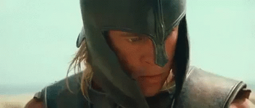 A Close Up Of A Man Wearing A Helmet And Armor Looking At The Camera . GIF