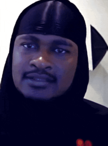 A Close Up Of A Man Wearing A Hood GIF