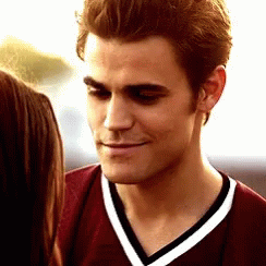 A Close Up Of A Man Wearing A Maroon Shirt With White Stripes GIF