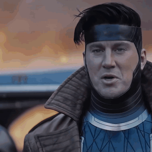 A Close Up Of A Man Wearing A Mask And A Jacket GIF