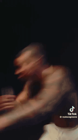 A Close Up Of A Man Wearing A Necklace . GIF