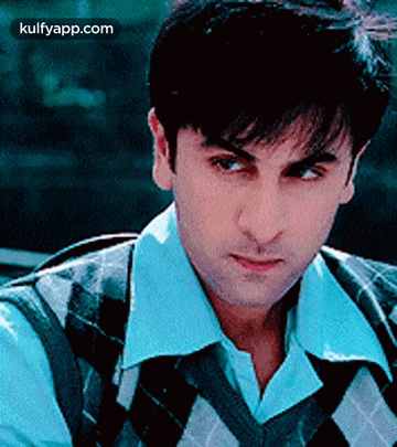 A Close Up Of A Man Wearing A Plaid Vest And A White Shirt . GIF