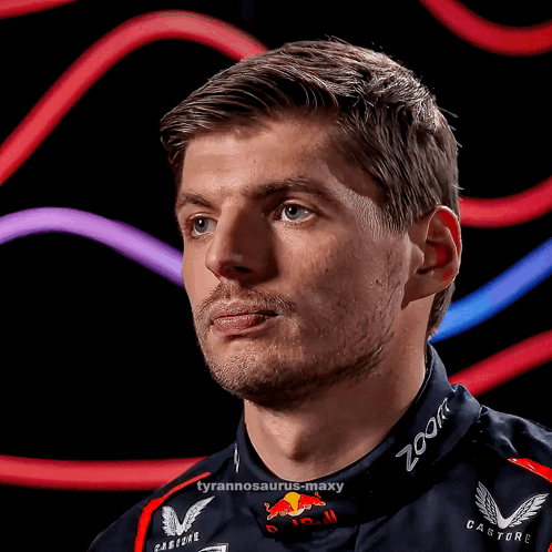 A Close Up Of A Man Wearing A Red Bull Racing Suit GIF